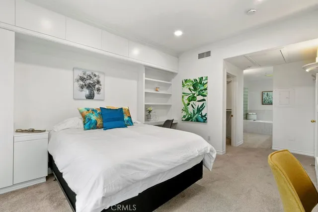 a bedroom with a bed and a couch