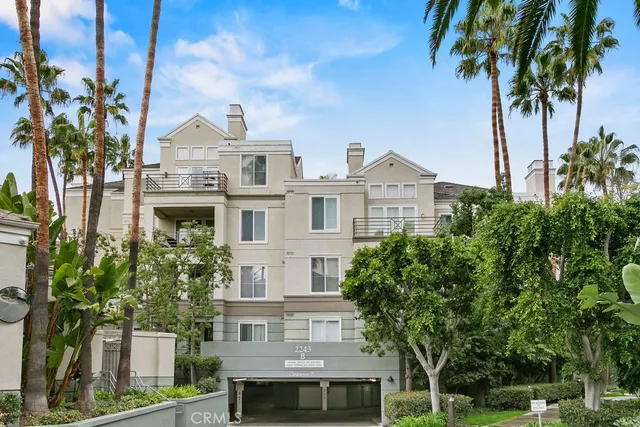 a front view of a residential houses with yard and green space