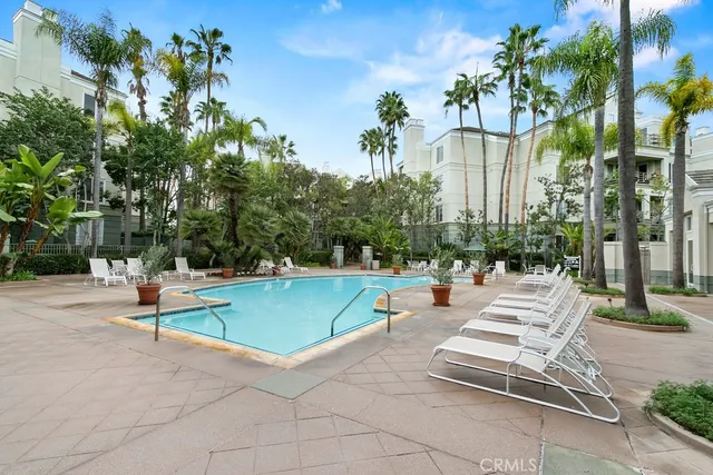 a view of a patio with swimming pool and sitting area
