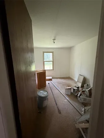 a room with a couch and wooden floor