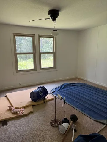 a room with gym equipment and windows