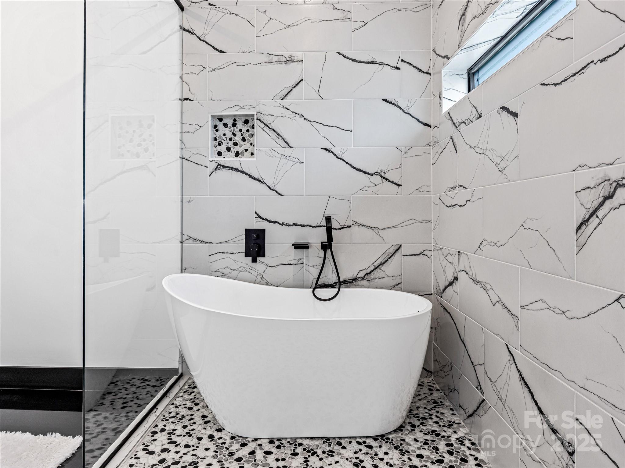 74 Jeranna Road Mills River, NC 28759 - Photo 13 of 42 a white tub sitting next to a shower