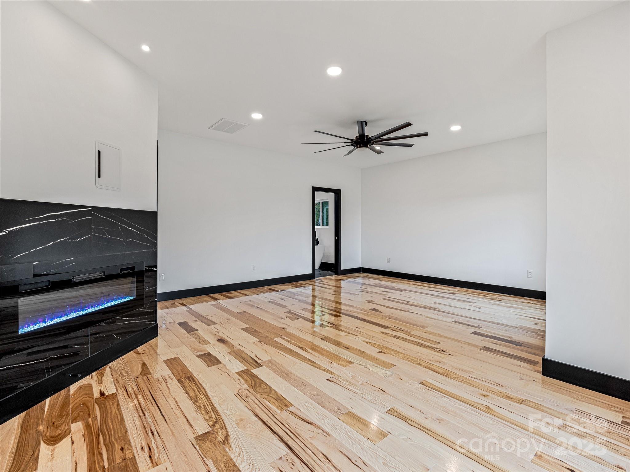 74 Jeranna Road Mills River, NC 28759 - Photo 28 of 42 a view of a room with wooden floor and a ceiling fan
