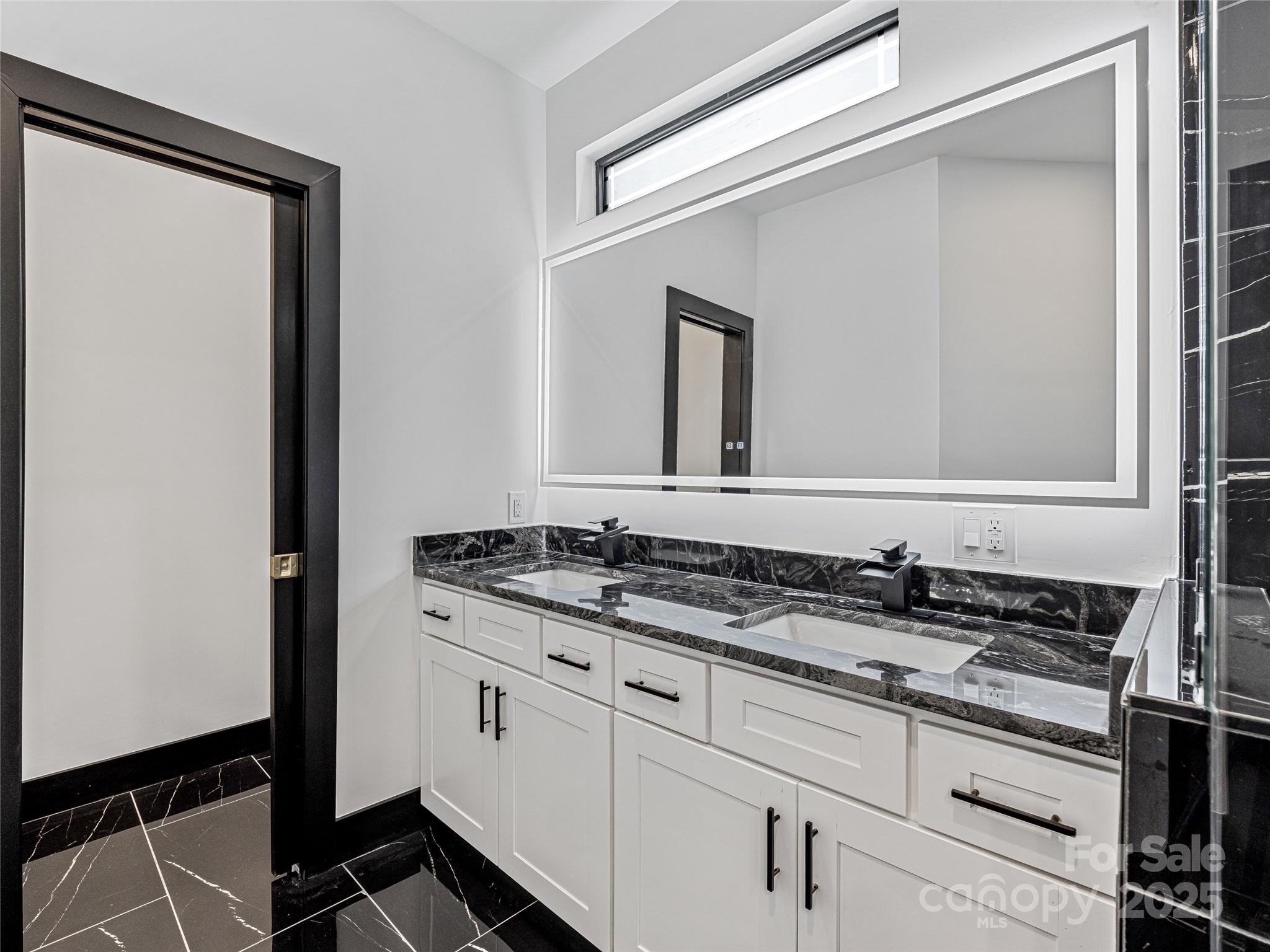 74 Jeranna Road Mills River, NC 28759 - Photo 30 of 42 a bathroom with a granite countertop sink and a mirror