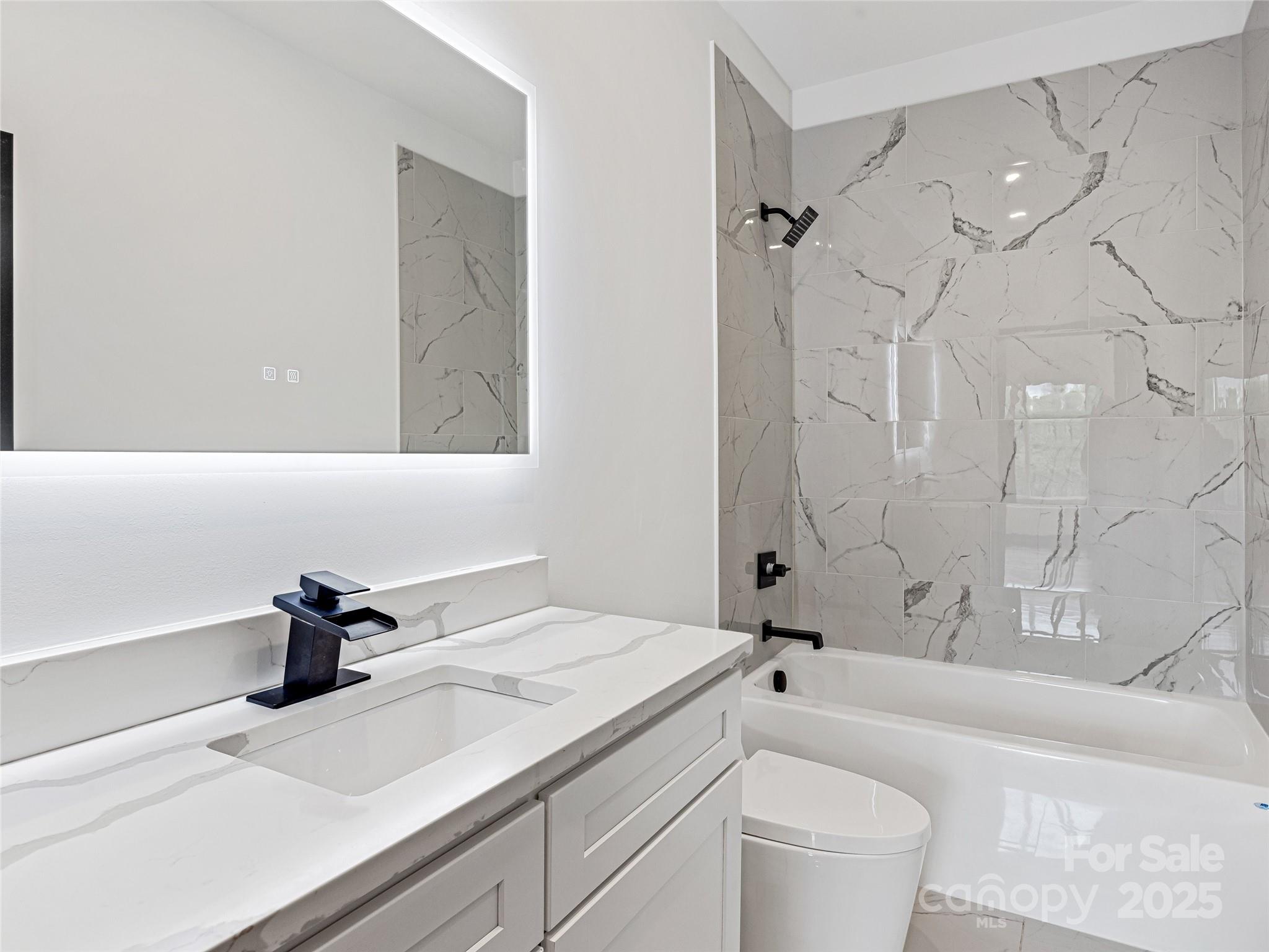 74 Jeranna Road Mills River, NC 28759 - Photo 32 of 42 a bathroom with a sink a toilet and a bathtub