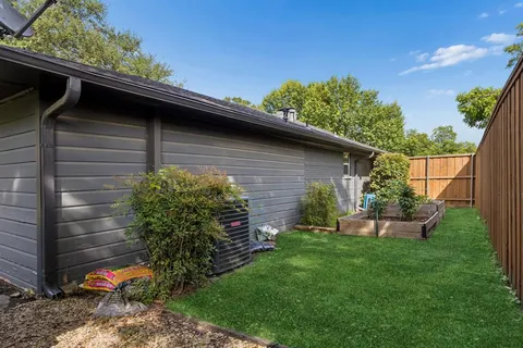 a view of a house with a yard and tree s