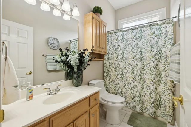 a spacious bathroom with a double vanity sink a mirror and a bathtub