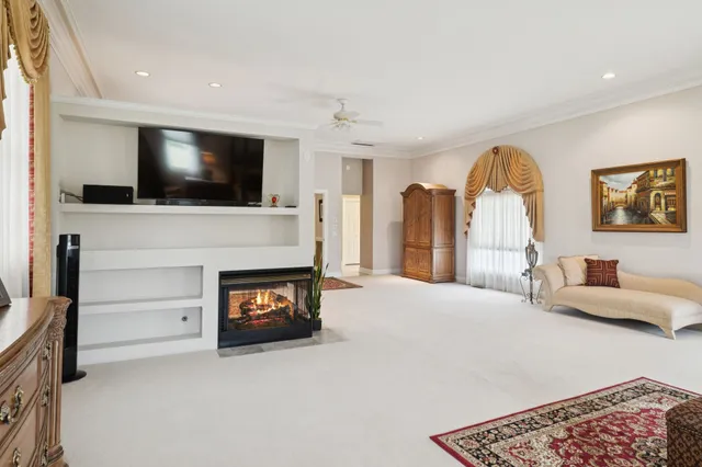 an aerial view of a house with table and chairs under an umbrella