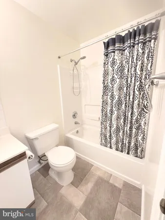 a bathroom with a toilet and shower