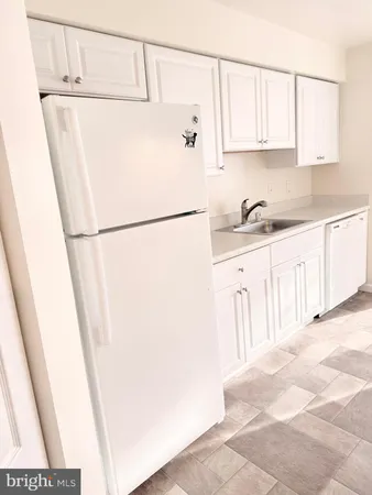 a white refrigerator freezer sitting inside of a kitchen