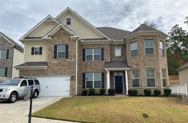 a front view of a house with parking space