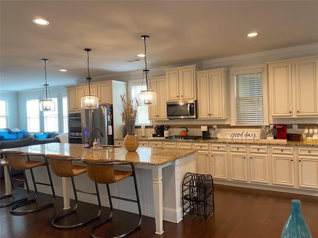 4806 Ralin Court Southwest Atlanta, GA 30331 - Photo 16 of 104 a kitchen with stainless steel appliances granite countertop a table chairs refrigerator and cabinets
