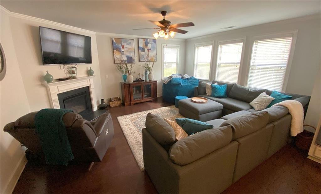 4806 Ralin Court Southwest Atlanta, GA 30331 - Photo 25 of 104 a living room with furniture a flat screen tv and a fireplace