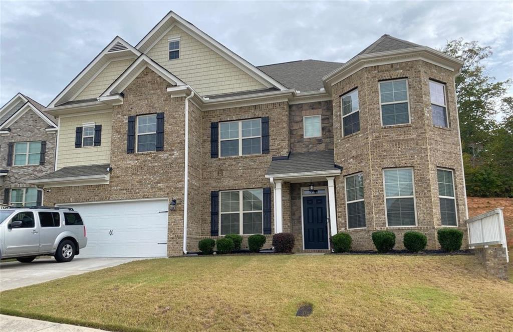 4806 Ralin Court Southwest Atlanta, GA 30331 - Photo 3 of 104 a view of a white house with large windows next to a yard