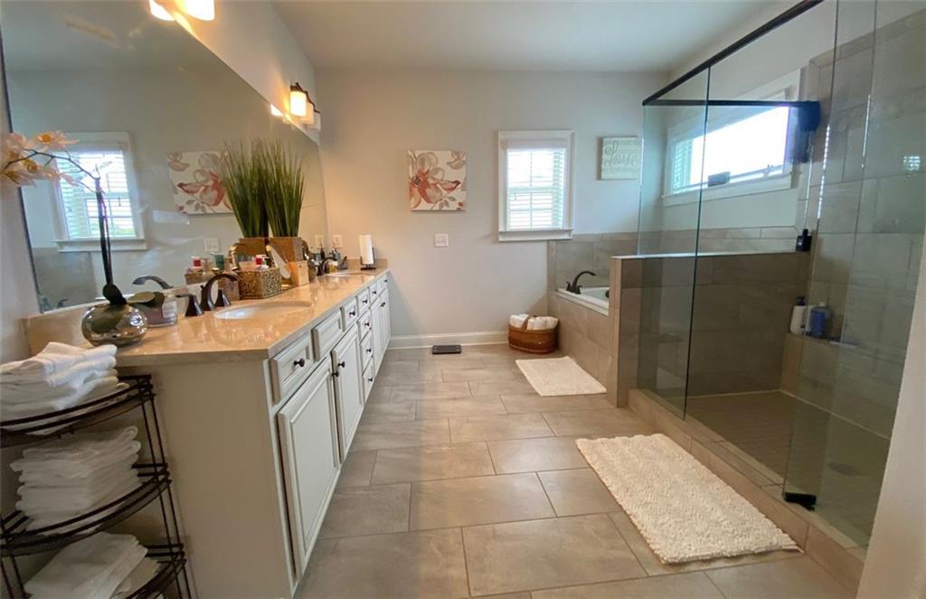 4806 Ralin Court Southwest Atlanta, GA 30331 - Photo 45 of 104 a bathroom with a sink a toilet a mirror and shower