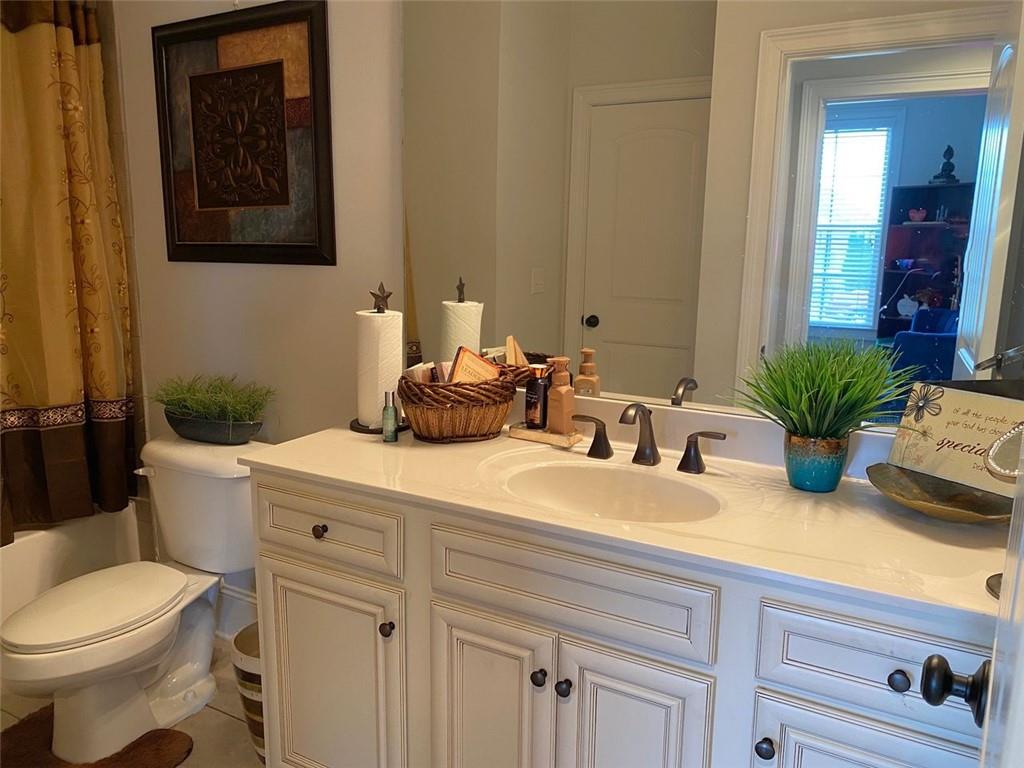 4806 Ralin Court Southwest Atlanta, GA 30331 - Photo 53 of 104 a bathroom with a granite countertop sink a toilet and mirror
