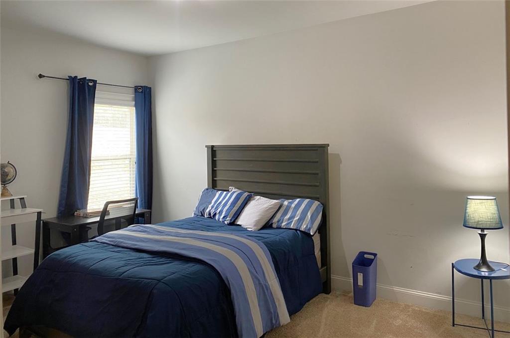 4806 Ralin Court Southwest Atlanta, GA 30331 - Photo 64 of 104 a bedroom with a bed and a lamp