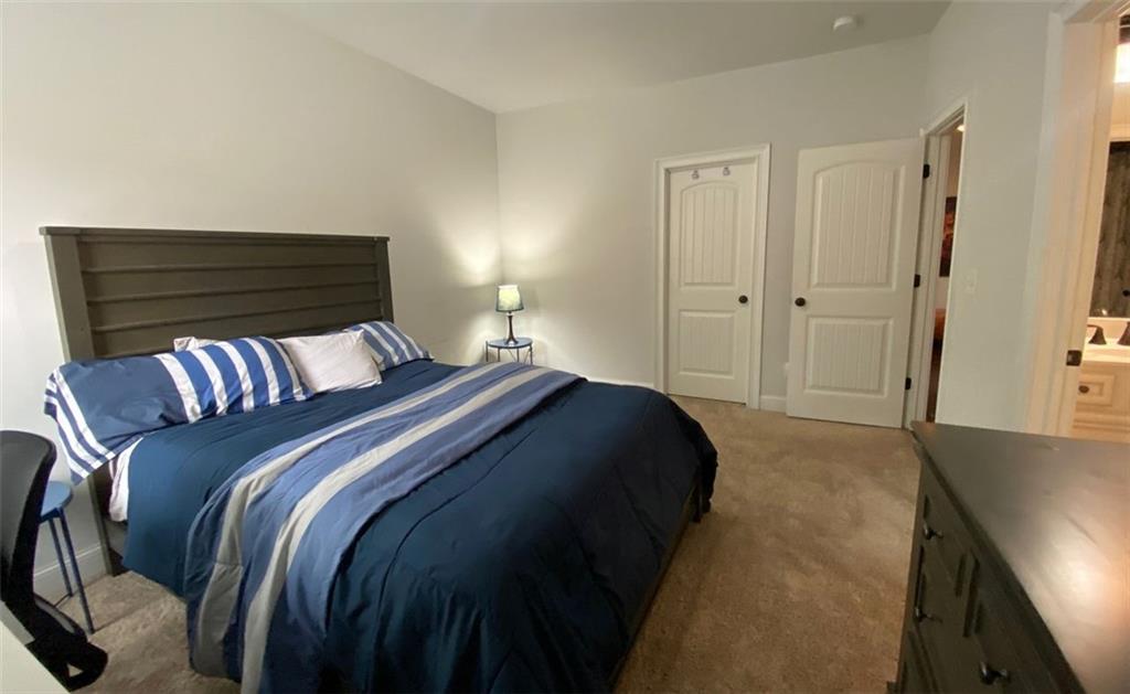 4806 Ralin Court Southwest Atlanta, GA 30331 - Photo 66 of 104 a bedroom with a bed and a painting on the wall