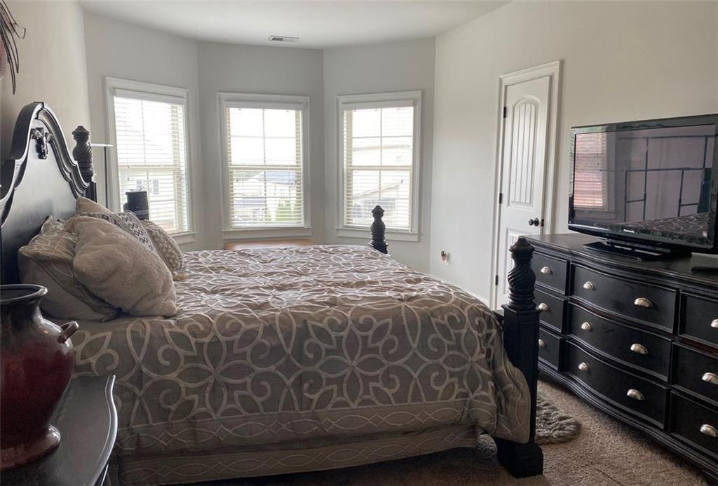 4806 Ralin Court Southwest Atlanta, GA 30331 - Photo 69 of 104 a bedroom with a bed and a dresser