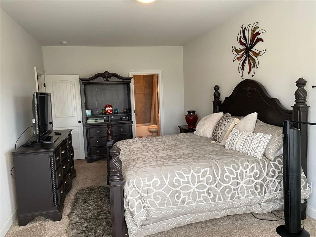 4806 Ralin Court Southwest Atlanta, GA 30331 - Photo 70 of 104 a bedroom with a bed and flat tv screen on the dresser