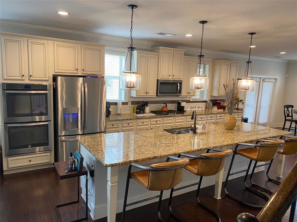 4806 Ralin Court Southwest Atlanta, GA 30331 - Photo 10 of 104 a kitchen with stainless steel appliances granite countertop a stove a refrigerator a kitchen island a sink cabinets and chairs