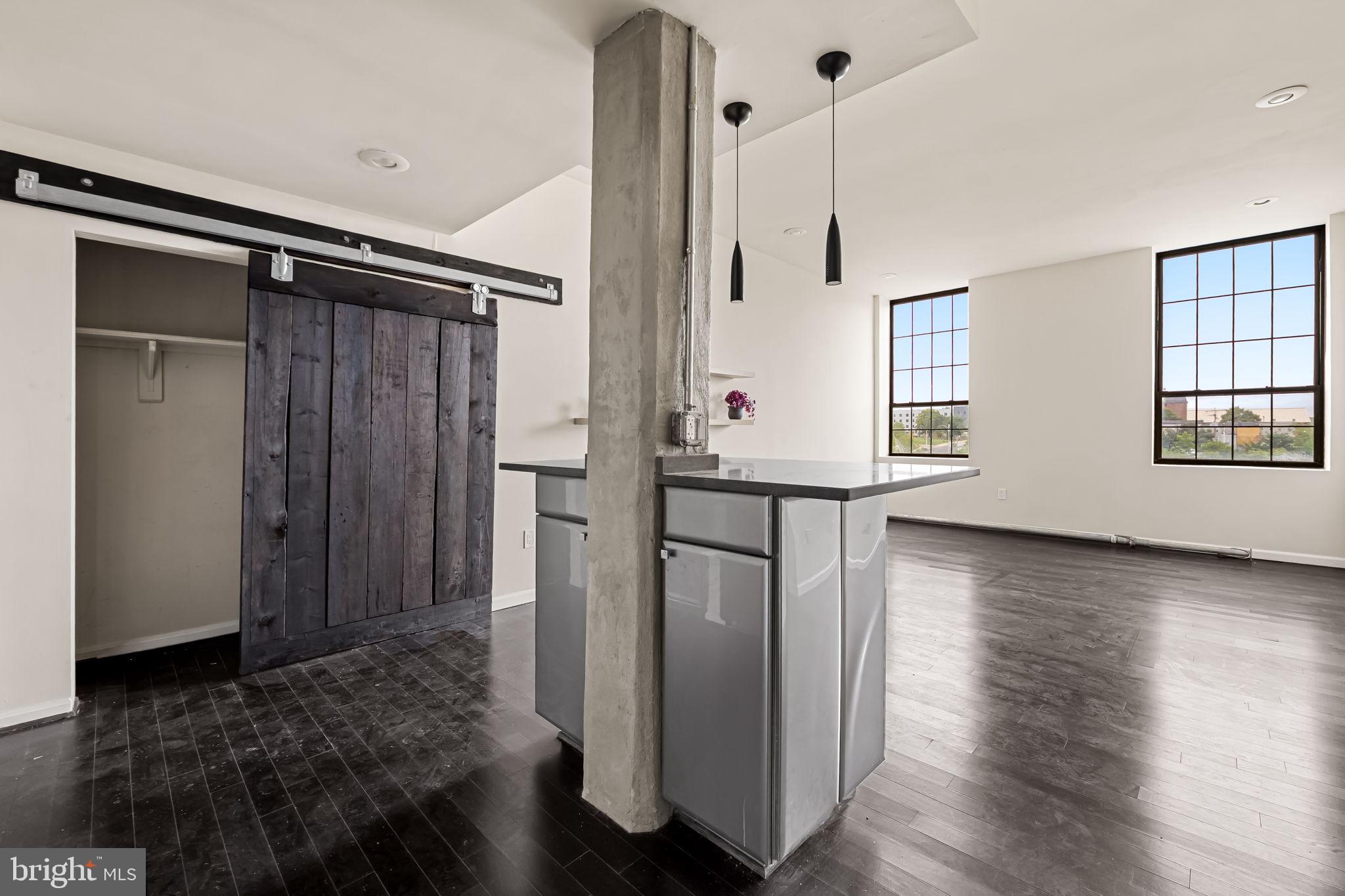 1011 Hunter Street, Unit A4 Baltimore, MD 21202 - Photo 23 of 34 a view of empty room with wooden floor and fan