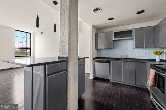 a kitchen with stainless steel appliances a refrigerator and a stove top oven