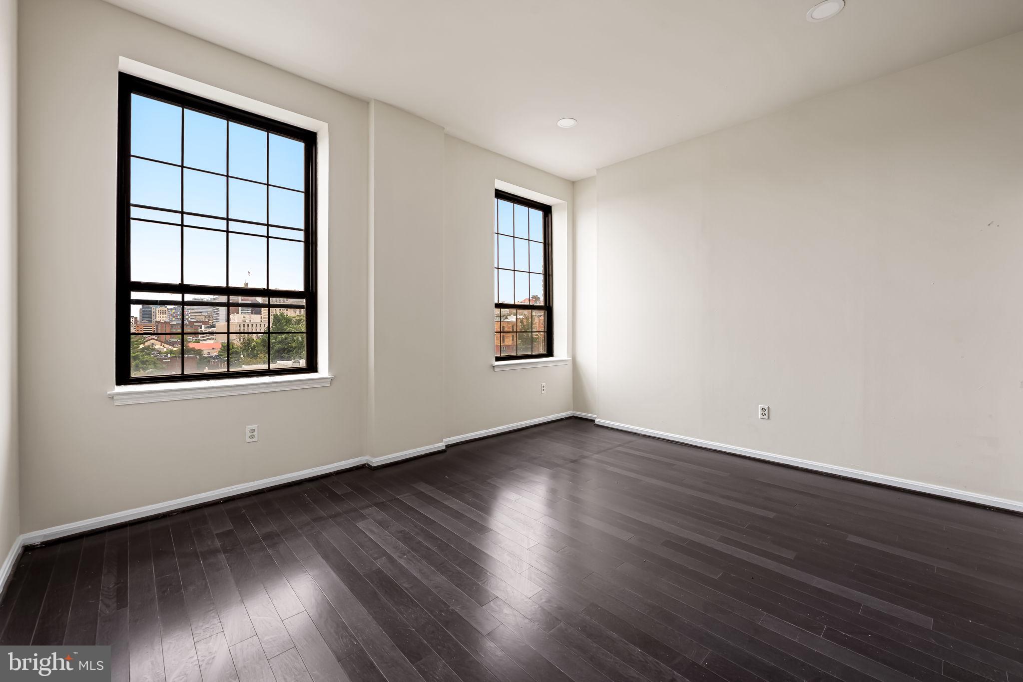 1011 Hunter Street, Unit A4 Baltimore, MD 21202 - Photo 28 of 34 a view of an empty room with wooden floor and a window