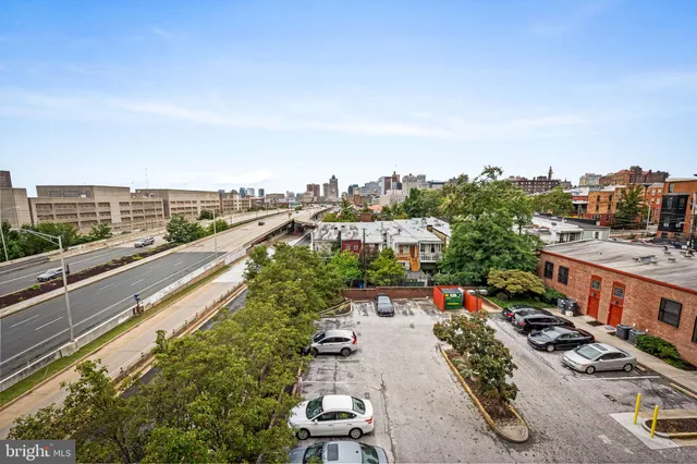 a view of city from balcony with furniture