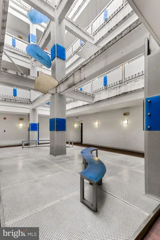 a lobby with a furniture and a ceiling fan