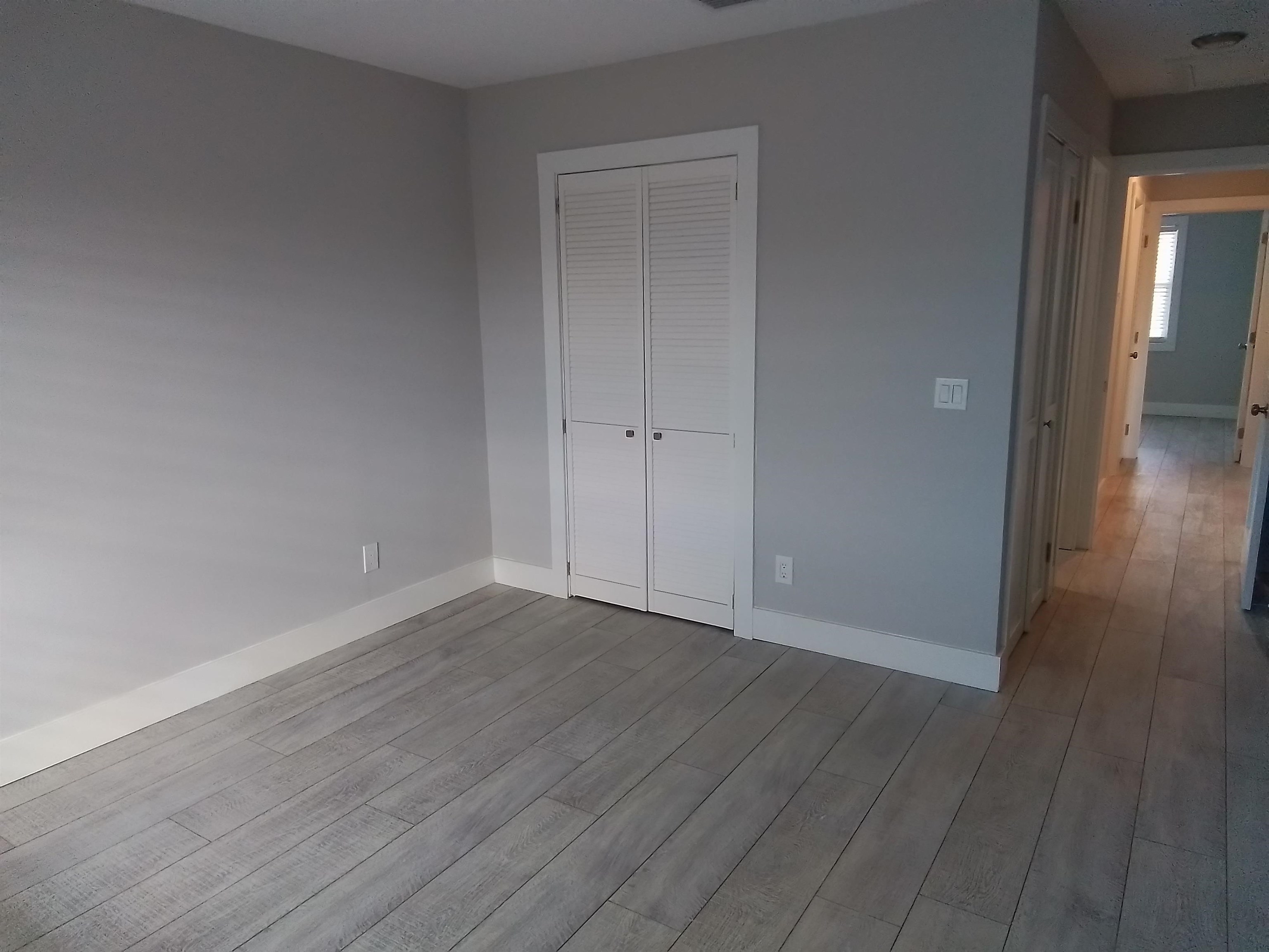650 West Pope Road, Unit 244 St. Augustine, FL 32080 - Photo 11 of 27 a view of an empty room with wooden floor and a window