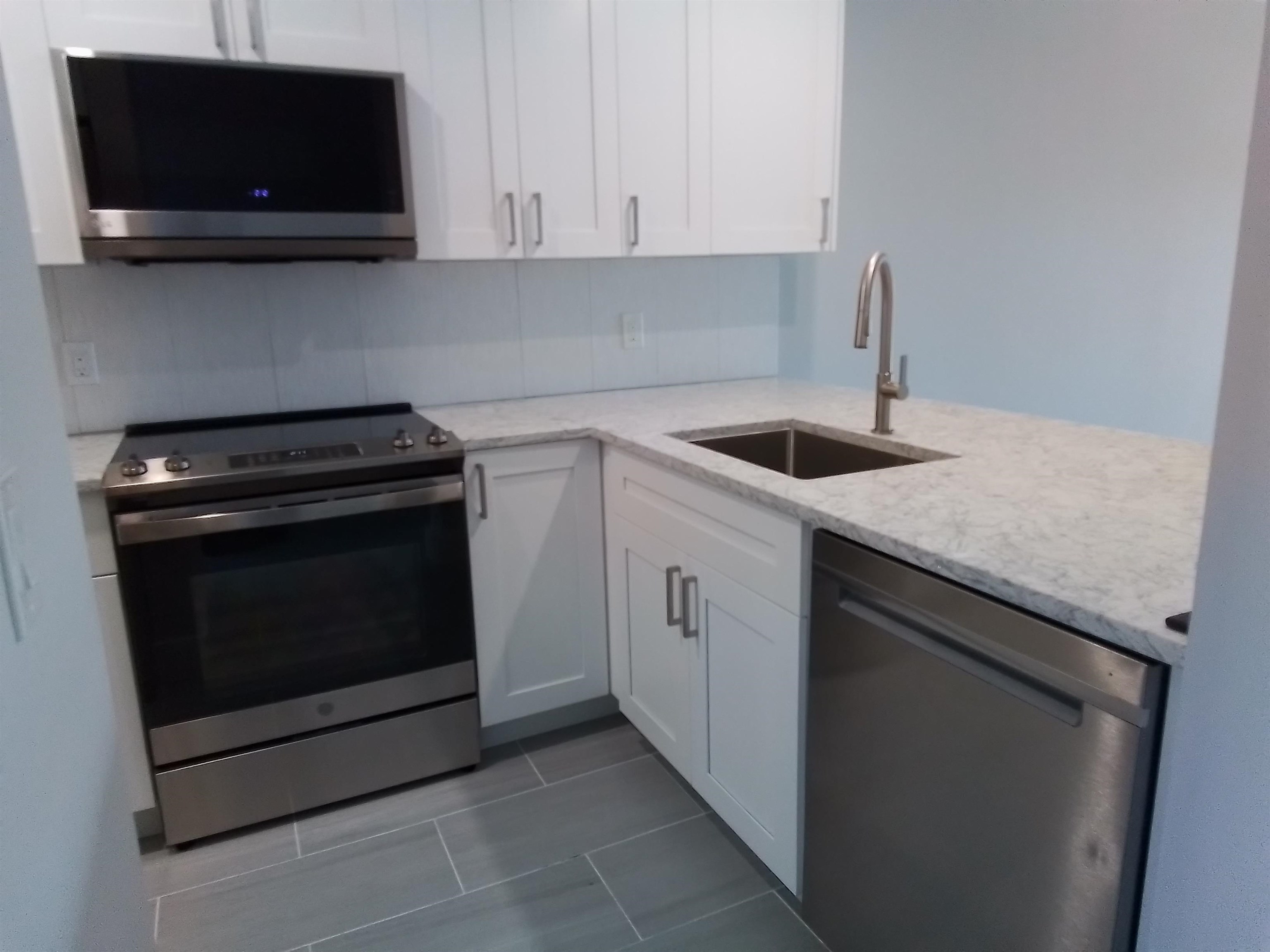 650 West Pope Road, Unit 244 St. Augustine, FL 32080 - Photo 22 of 27 a kitchen with a stove and a microwave