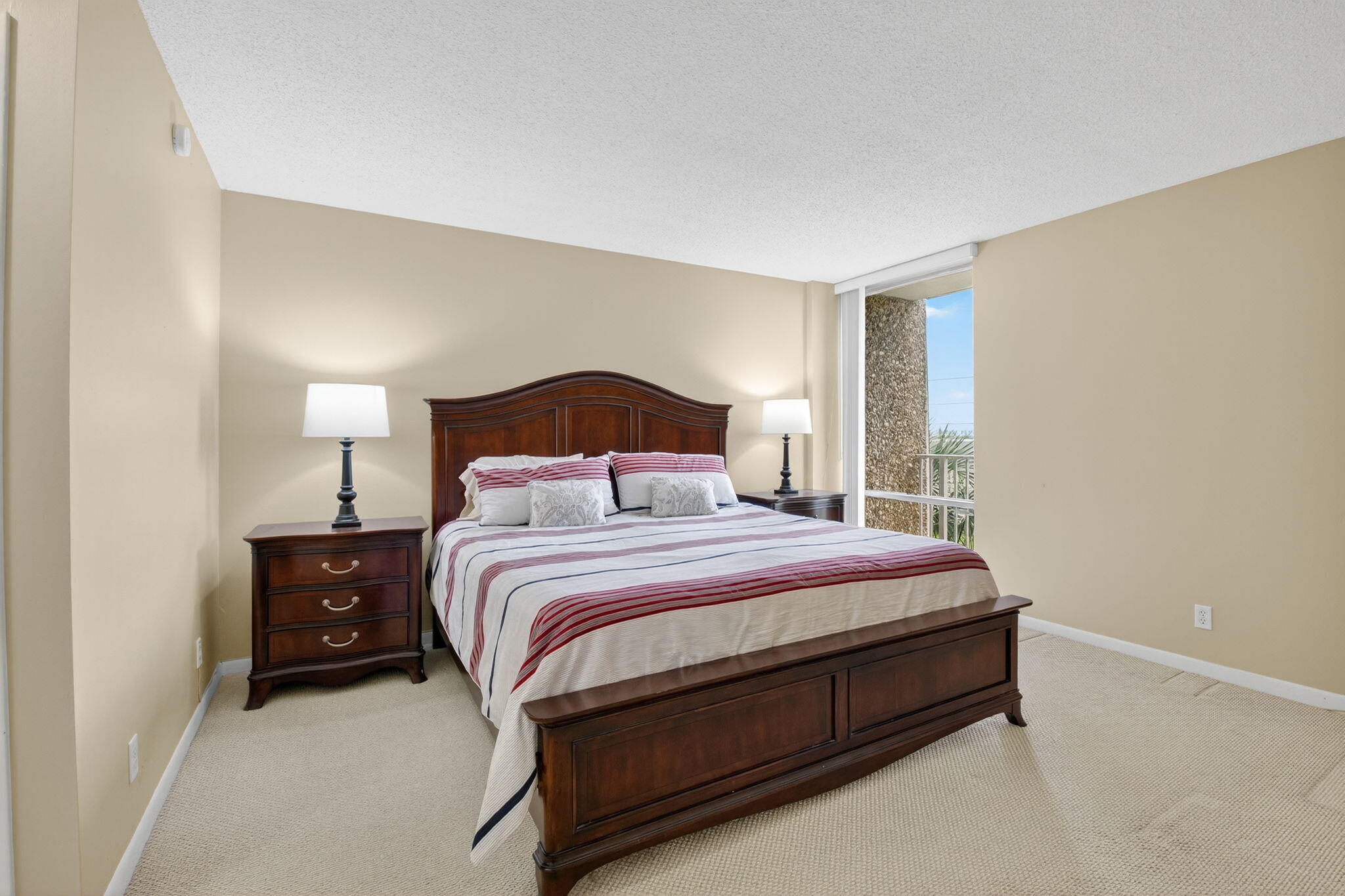 555 Northwest 4th Avenue, Unit 4230 Boca Raton, FL 33432 - Photo 15 of 38 a bedroom with a bed and a night stand