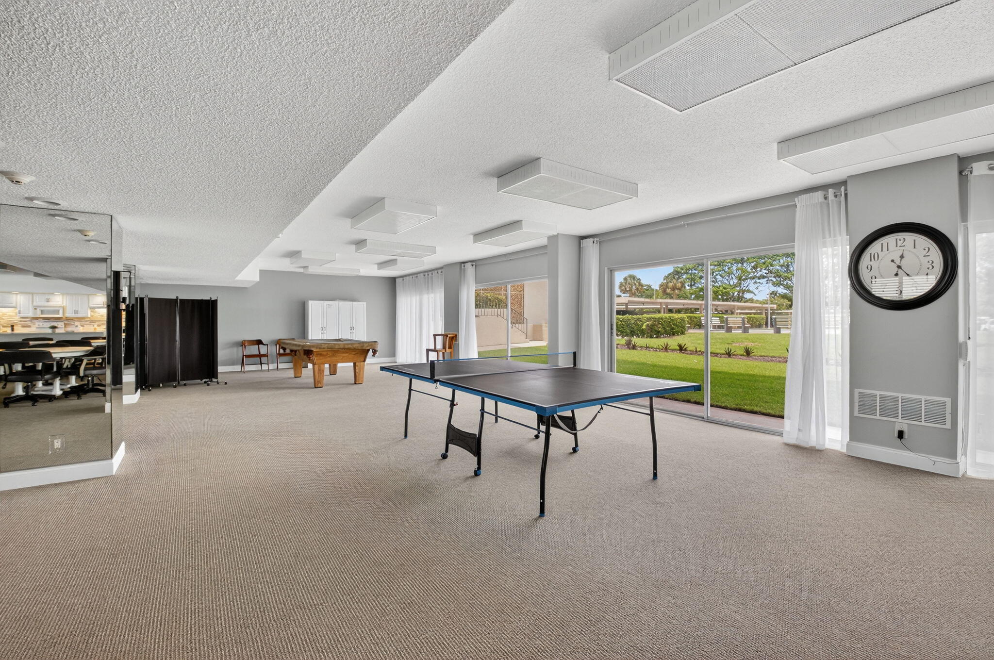 555 Northwest 4th Avenue, Unit 4230 Boca Raton, FL 33432 - Photo 26 of 38 a living room with furniture a clock and a large window