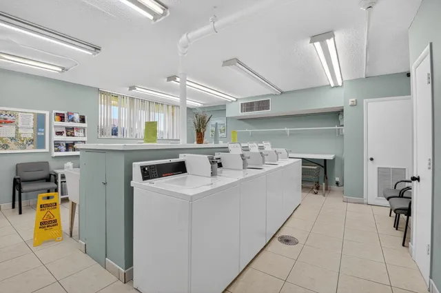 a kitchen with a sink a counter top space stainless steel appliances and cabinets