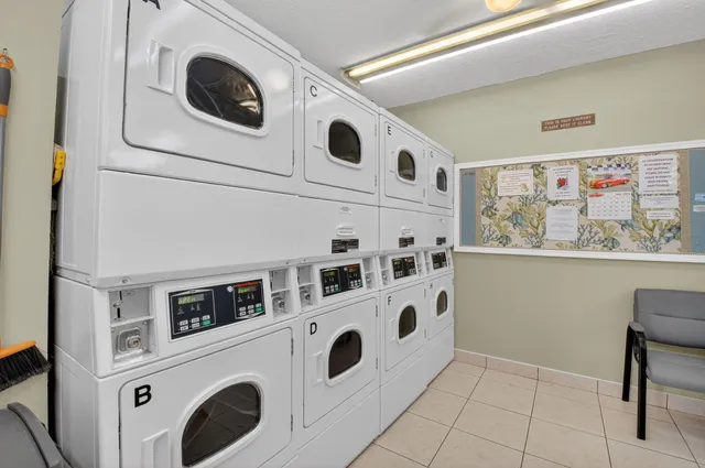a view of washer and dryer with kitchen in the background