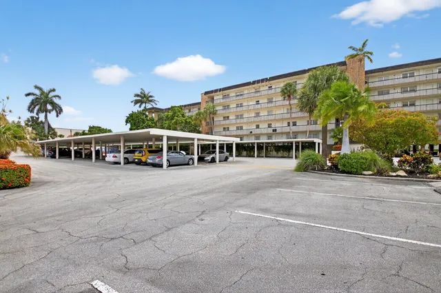 a view of a building with cars parked