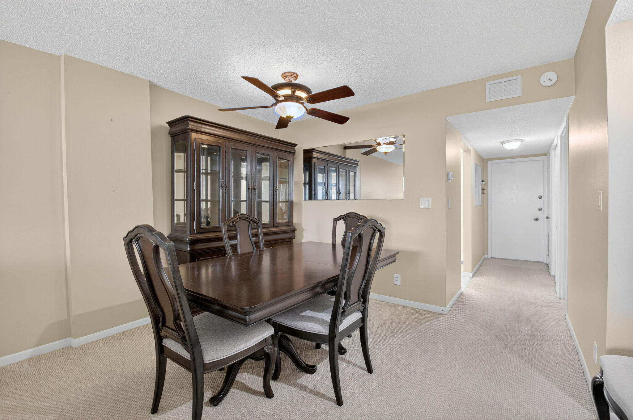 555 Northwest 4th Avenue, Unit 4230 Boca Raton, FL 33432 - Photo 6 of 38 a view of a dining room with furniture and a chandelier fan
