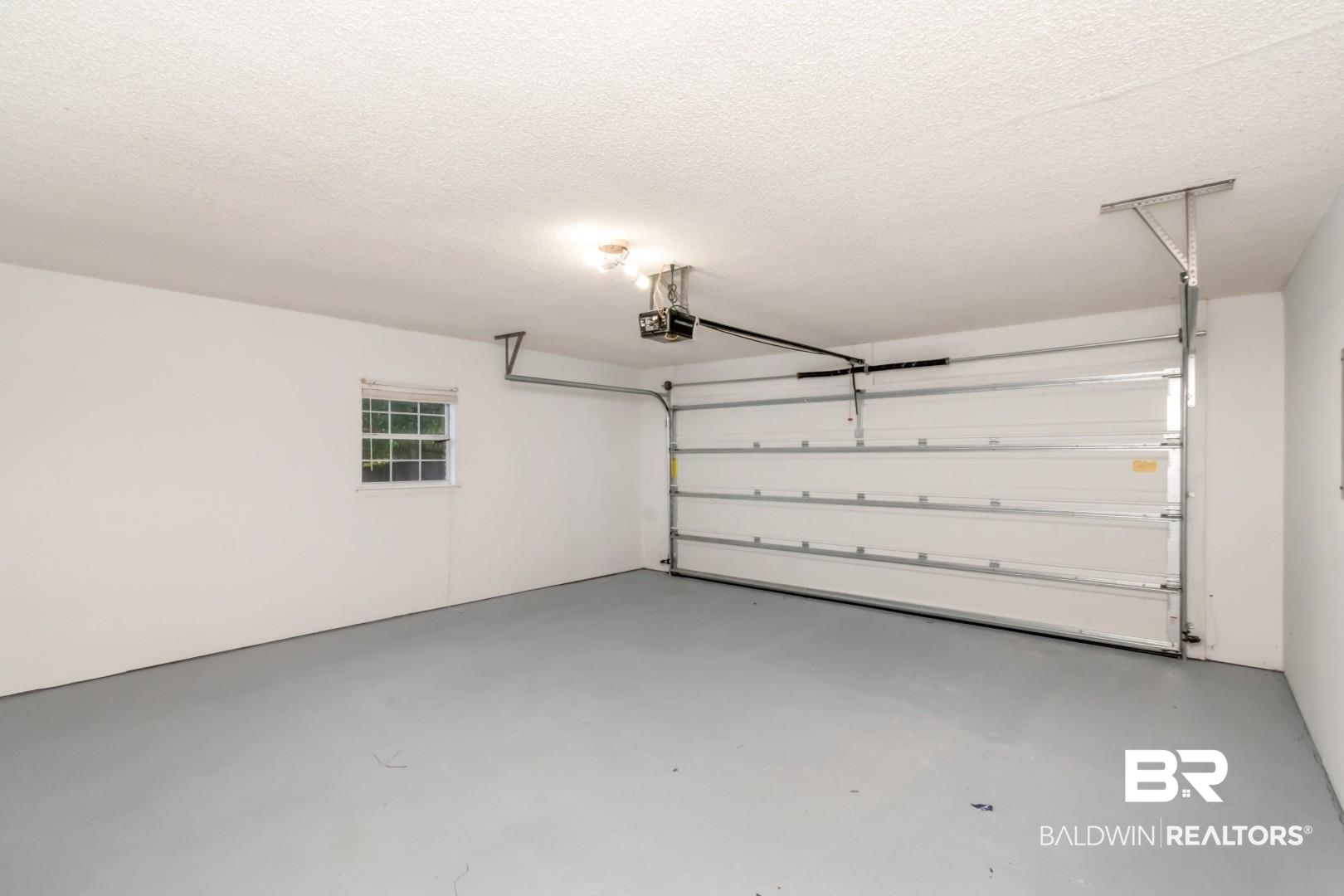 6482 Cedar Bend Court Mobile, AL 36608 - Photo 11 of 26 Garage featuring a garage door opener