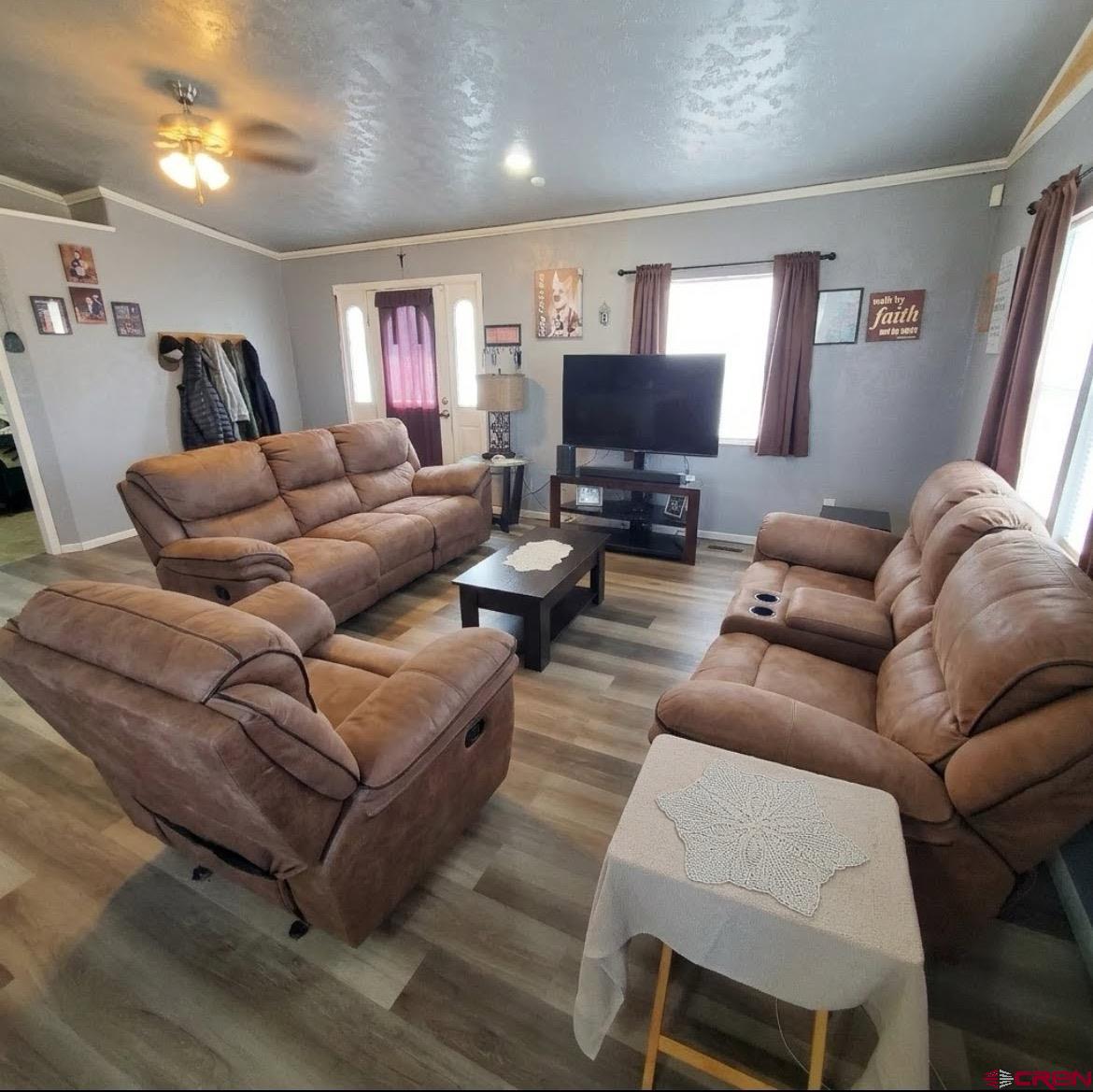 816 Main Street Manassa, CO 81141 - Photo 7 of 23 a living room with furniture a flat screen tv and a fireplace