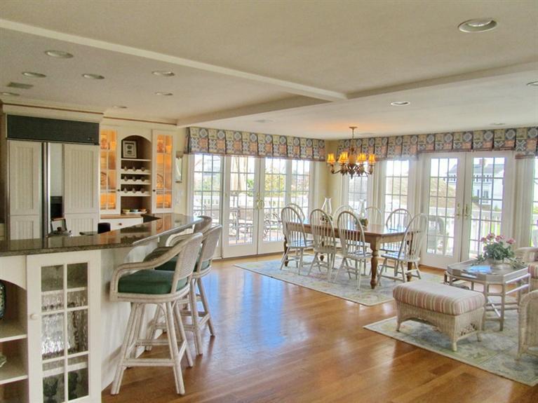 11 Pilgrim Road Harwich Port, MA 02646 - Photo 8 of 24 a living room with furniture a dining table and a large window