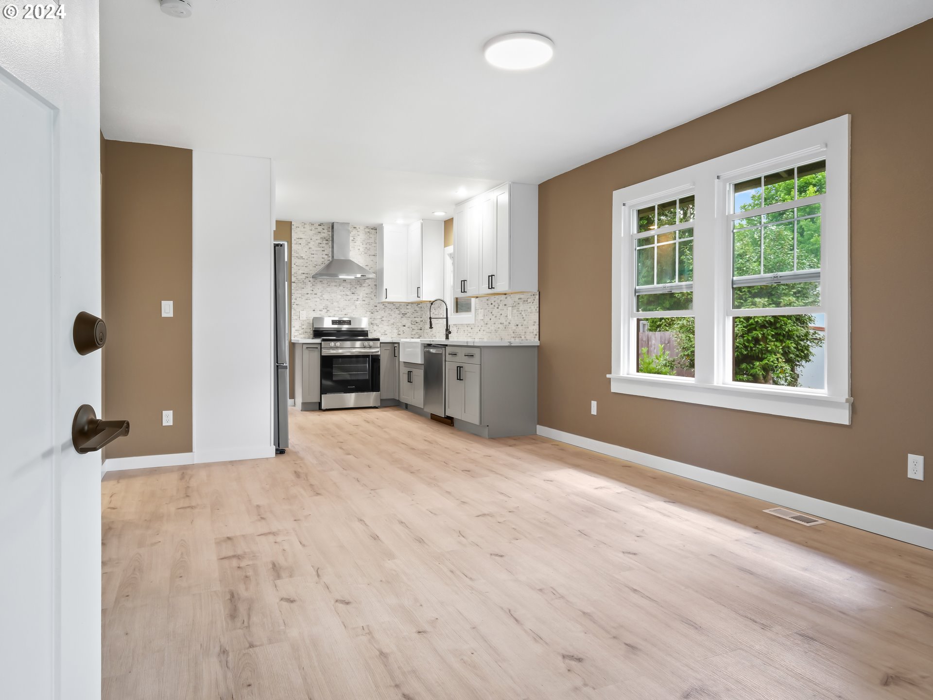 1903 14th Street Oregon City, OR 97045 - Photo 4 of 34 a view of a kitchen with kitchen island wooden floor and stainless steel appliances