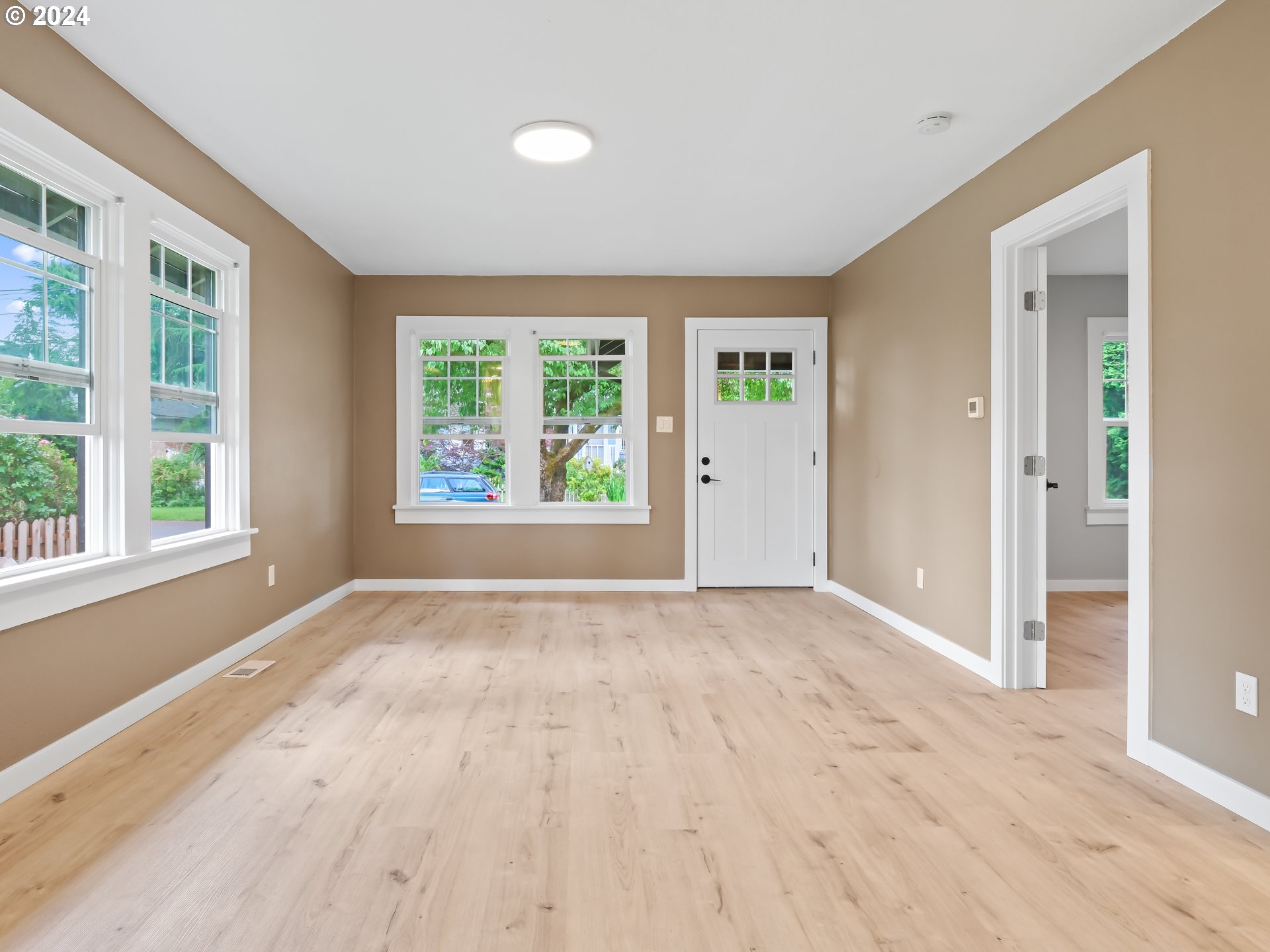 1903 14th Street Oregon City, OR 97045 - Photo 8 of 34 a view of an empty room with wooden floor and a window