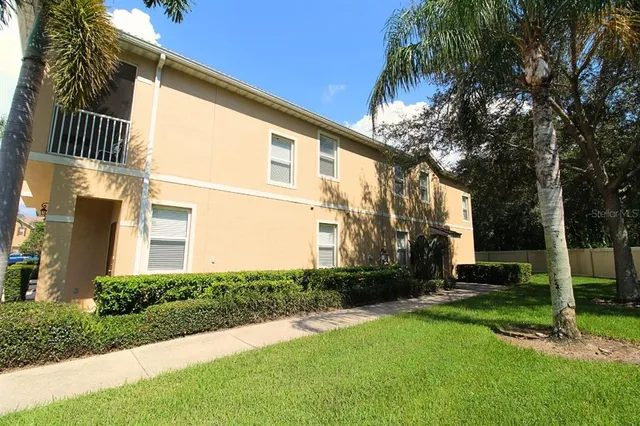 a view of a house with a backyard and a patio