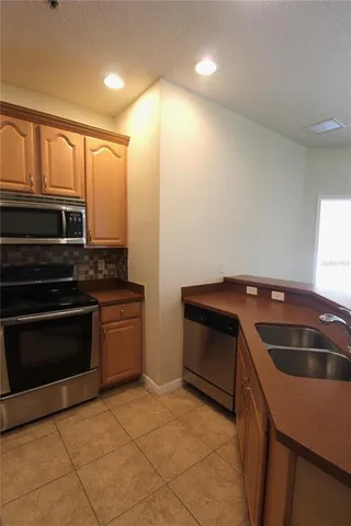 a kitchen that has a sink and a stove