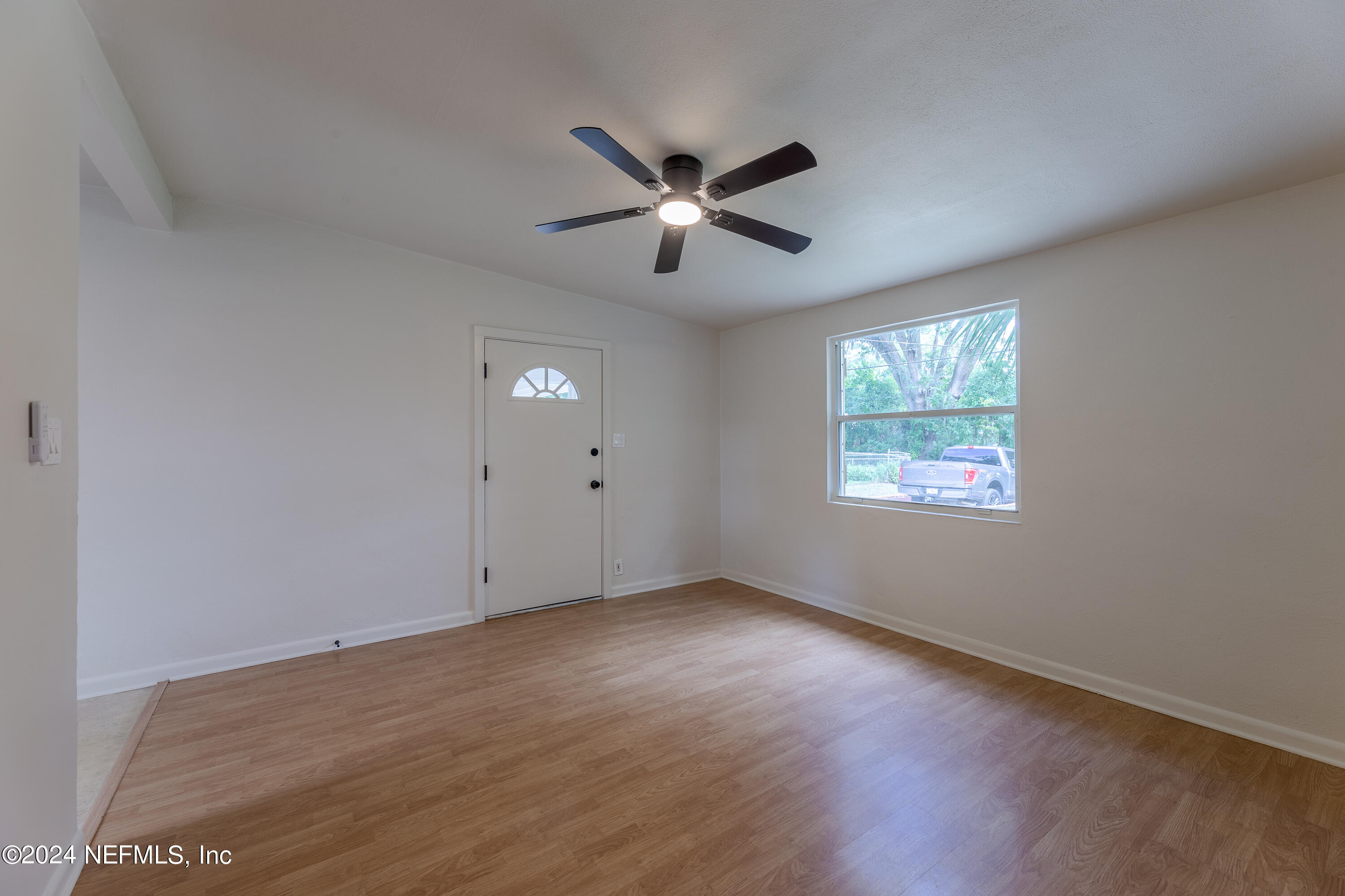 90 Spring Street St. Augustine, FL 32084 - Photo 8 of 24 an empty room with wooden floor ceiling fan and windows