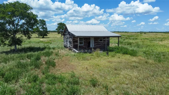 a view of house with backyard