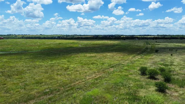a view of a lake in between of the building and trees