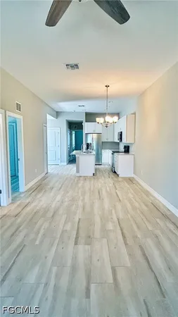 a view of a kitchen with granite countertop cabinets