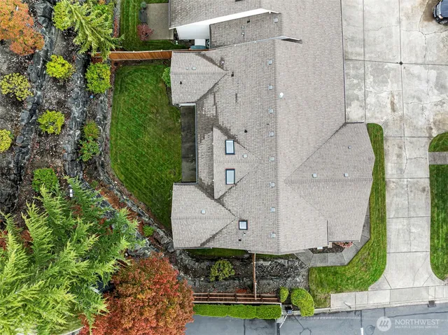 an aerial view of a house with garden space and street view